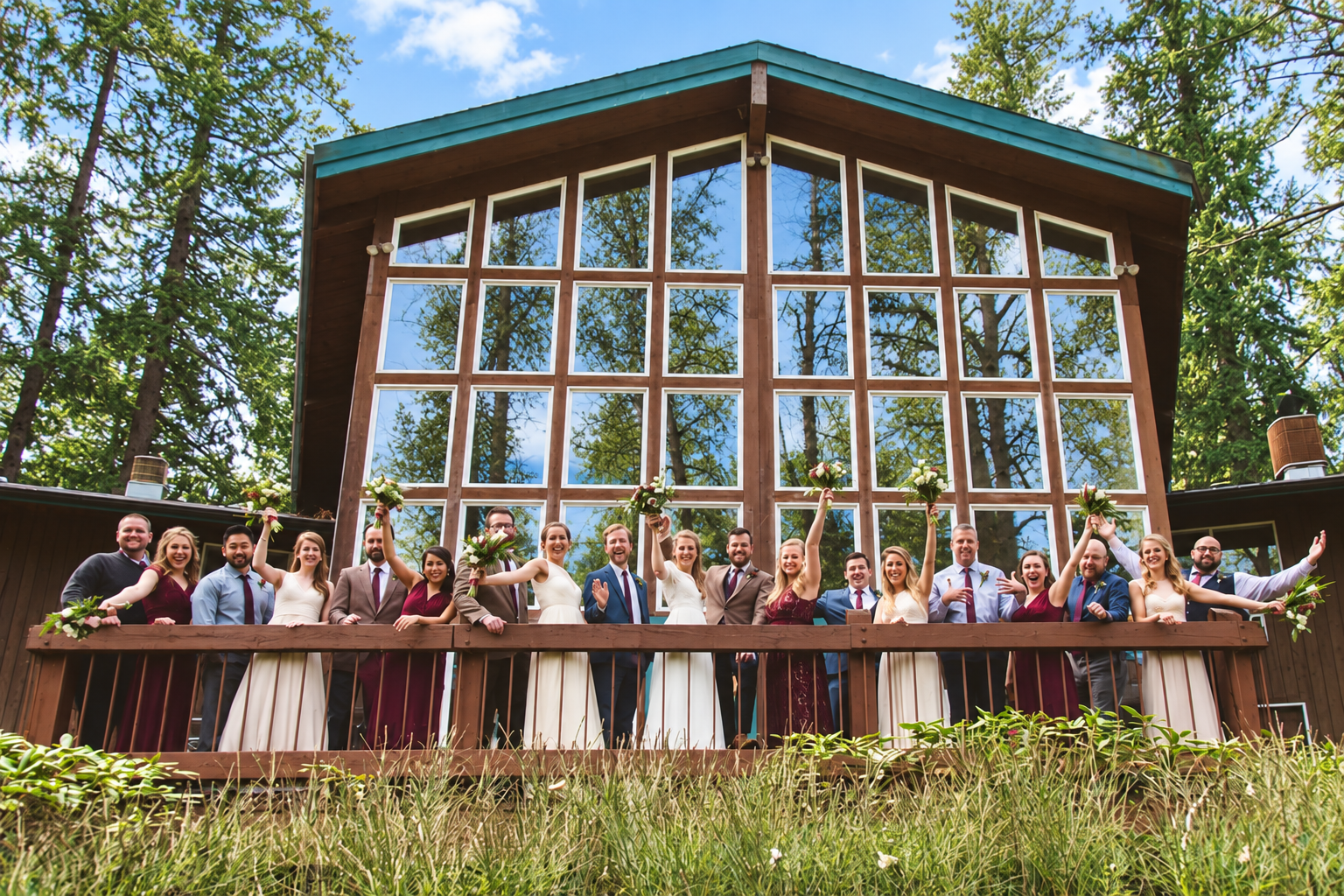Riverfront Lodge exterior surrounded by bright trees with reflections in the windows
